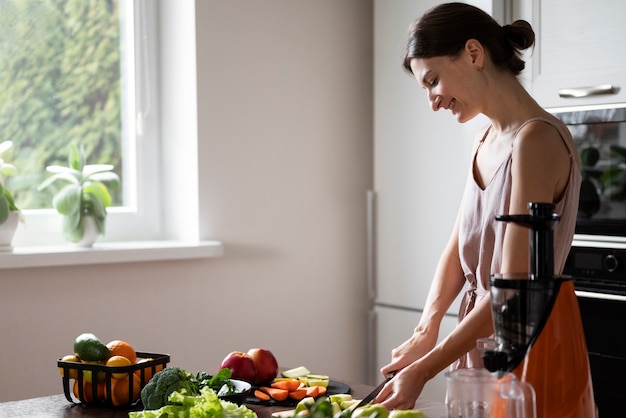 Free photo woman preparing her juice recipe