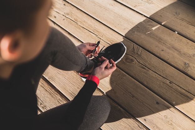 Woman preparing her sneakers before starting to run