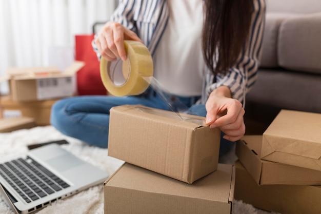 Woman preparing a package for cyber monday