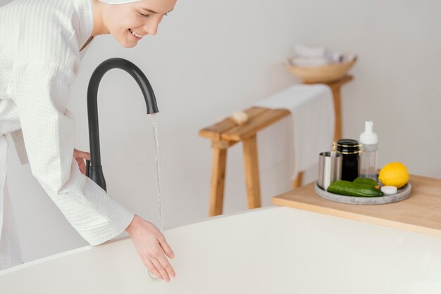 Woman preparing a relaxing bath