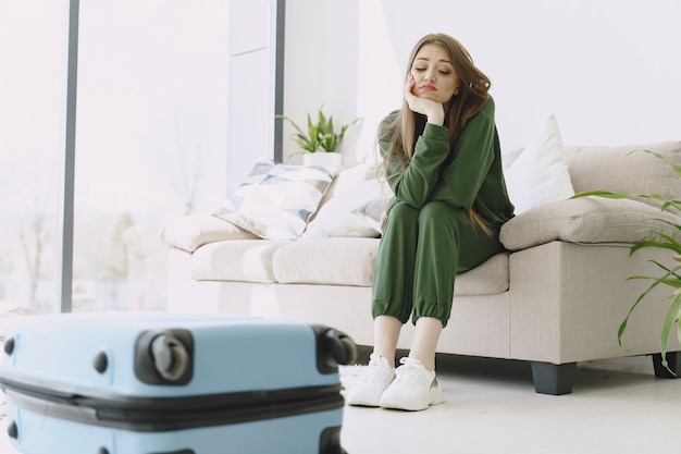 Woman preparing travel suitcase at home