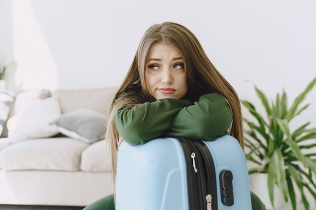 Woman preparing travel suitcase at home