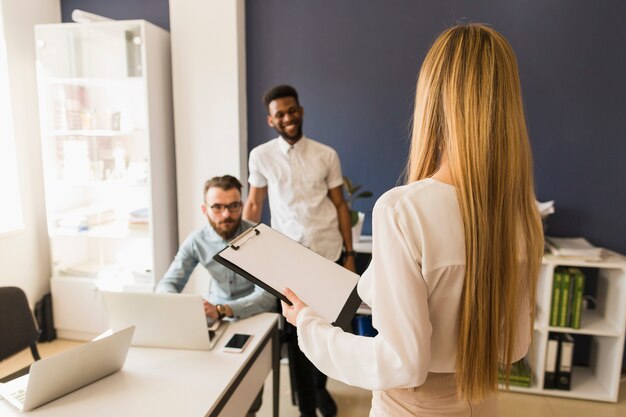 女性が同僚に情報を提示する