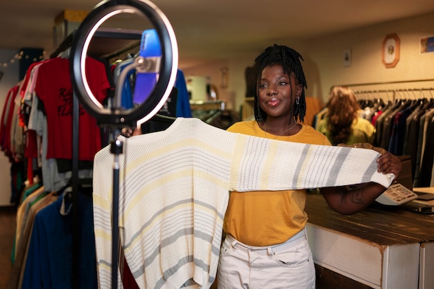 Free photo woman promoting cloths from thrift store