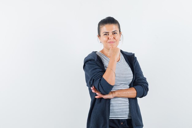 Free photo woman propping chin on fist in t-shirt