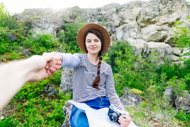 Woman pulling on boyfriends hand in nature