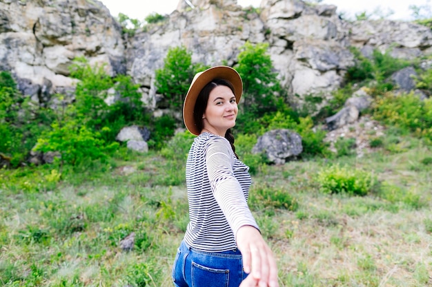 Woman pulling on boyfriends hand in nature