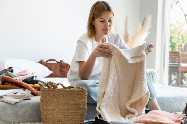 Woman putting clothes in a suitcase for the next vacation