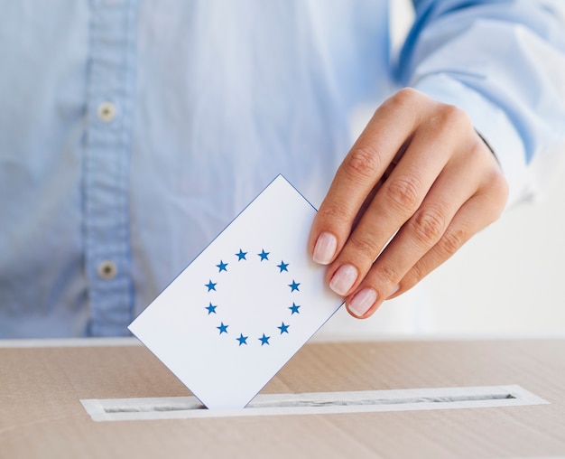 Woman putting an european ballot in box