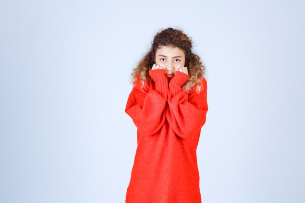 woman putting her fists to her chin and listening attentively with excitement. 