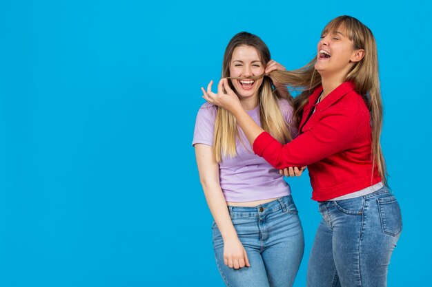 Woman putting on her girlfriend hair mustache