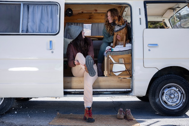 Free photo woman putting on her shoes to go on a winter adventure