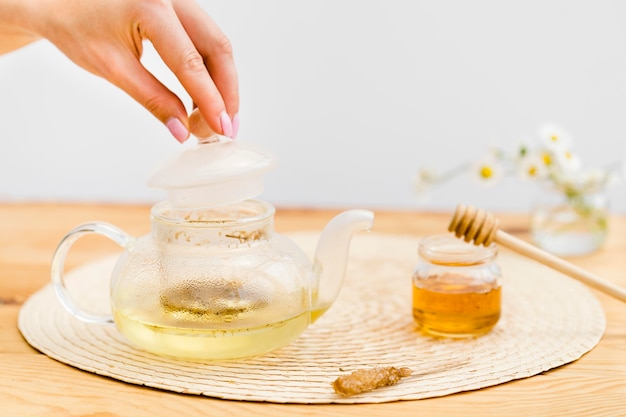 Woman putting lid over teapot