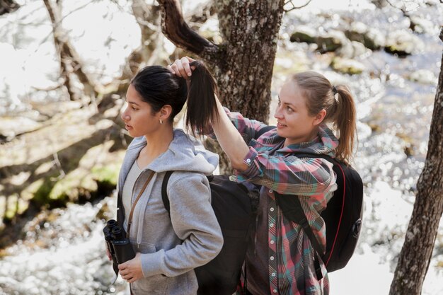 Woman putting up her friend's hair