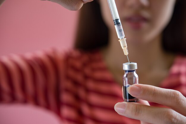 woman putting a vaccine