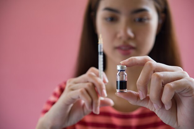 woman putting a vaccine