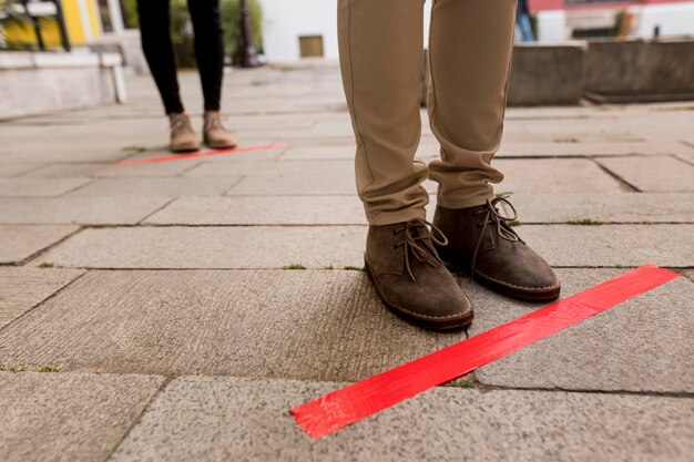 Woman in queue outdoors with tape