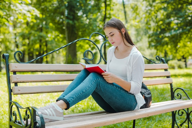 Woman reading book on beach