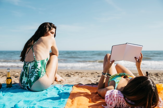 Woman reading book at the beach