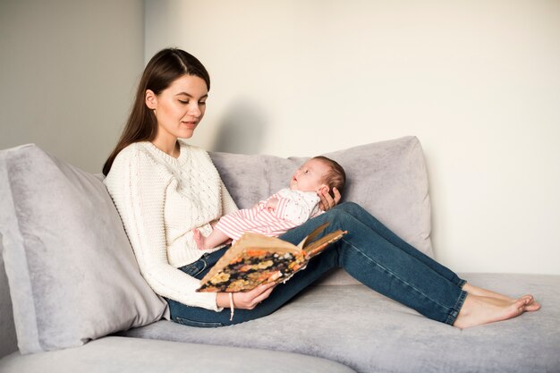 Woman reading book to daughter