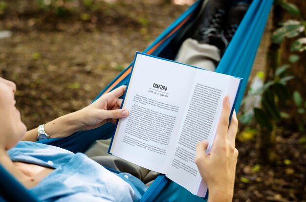 Woman reading a book in a hammock