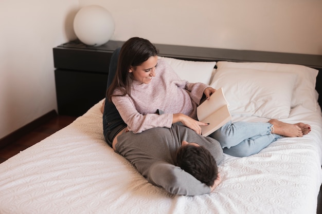 Free photo woman reading book to husband