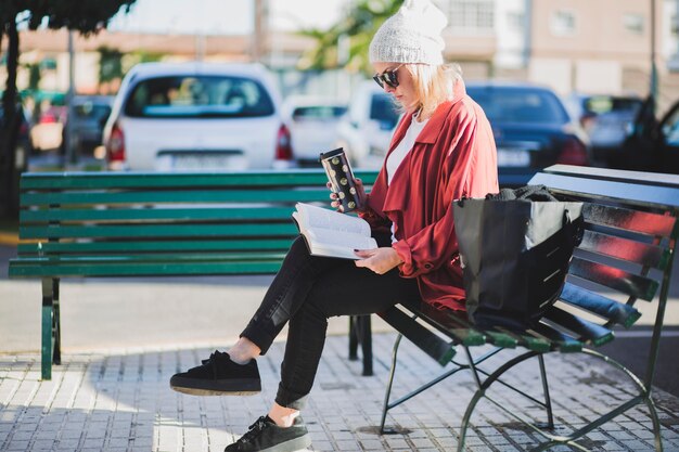 Woman reading book on street