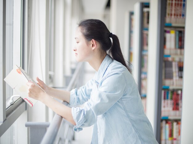 女太陽光を使って本を読んで