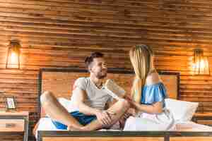 Free photo woman reading book while her smiling boyfriend looking at her