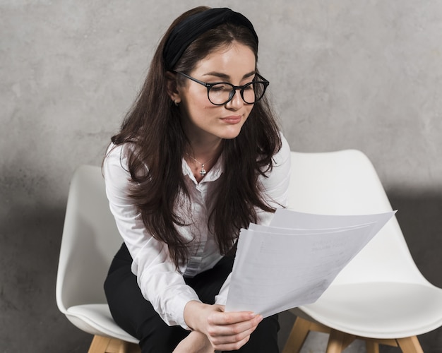 Woman reading her resume before attending a job interview