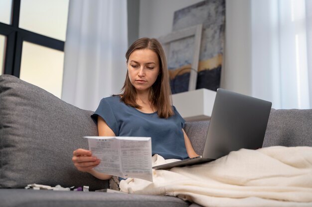 Woman reading the instructions for a covid test at home