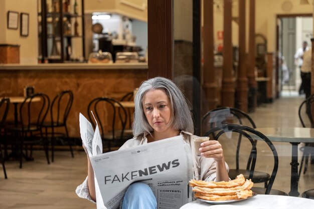 Woman reading the newspaper medium shot