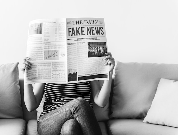 Free photo woman reading newspaper