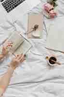 Free photo woman reading a novel on her bed on a sunday afternoon