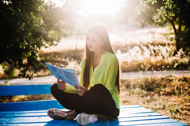 Woman reading papers in park