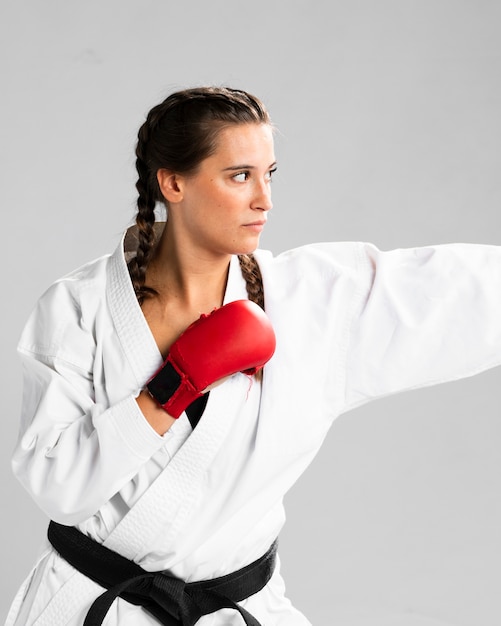 Free photo woman ready to fight with box gloves on white background