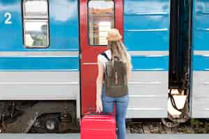 Free photo woman ready to take the train from behind