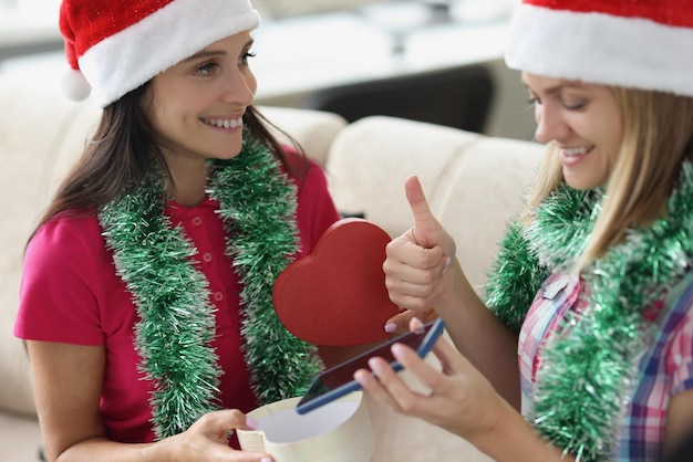 Woman receive present from sister in red box new model of smartphone