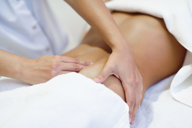 Woman receiving a belly massage at spa salon