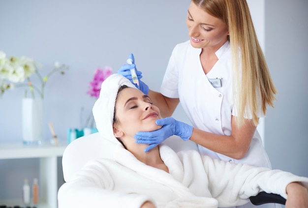 Woman receiving botox injection in clinic