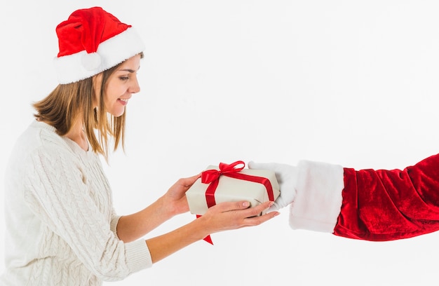 Woman receiving gift box from Santa Claus