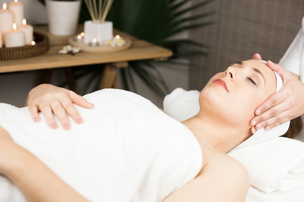 Woman receiving massage in spa center