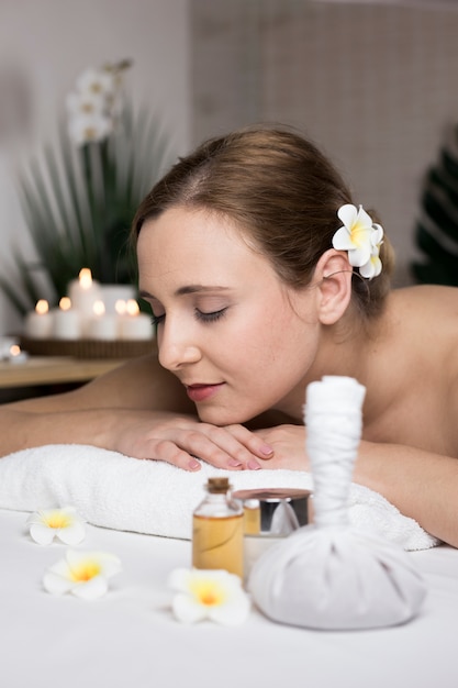 Woman receiving massage in spa center