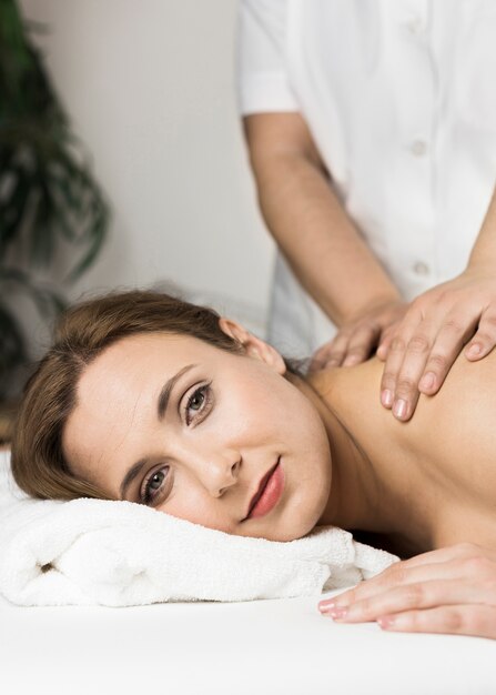 Woman receiving massage in spa center