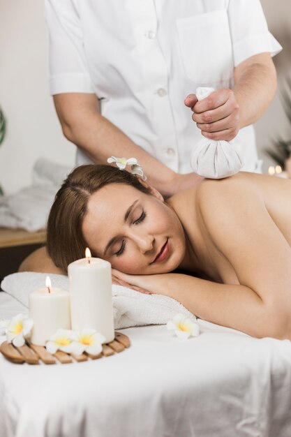 Woman receiving massage in spa center