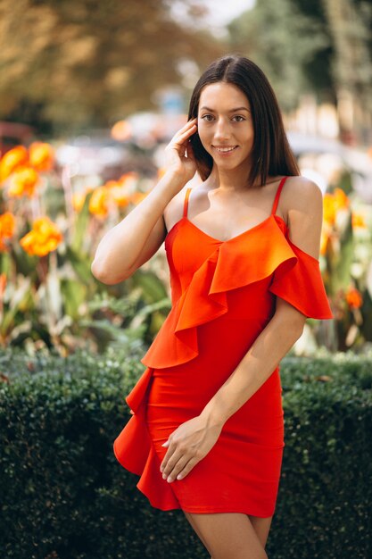 Woman in red dress outside in park