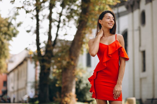 Woman in red dress outside in town