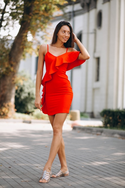 Woman in red dress outside in town