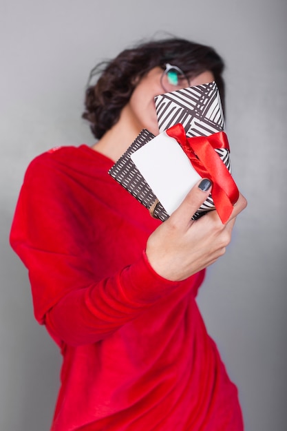 Woman in red dress showing gifts 