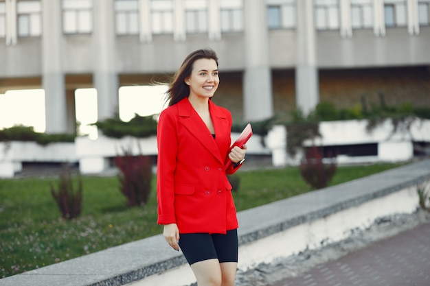 Woman in red jacket using a tablet